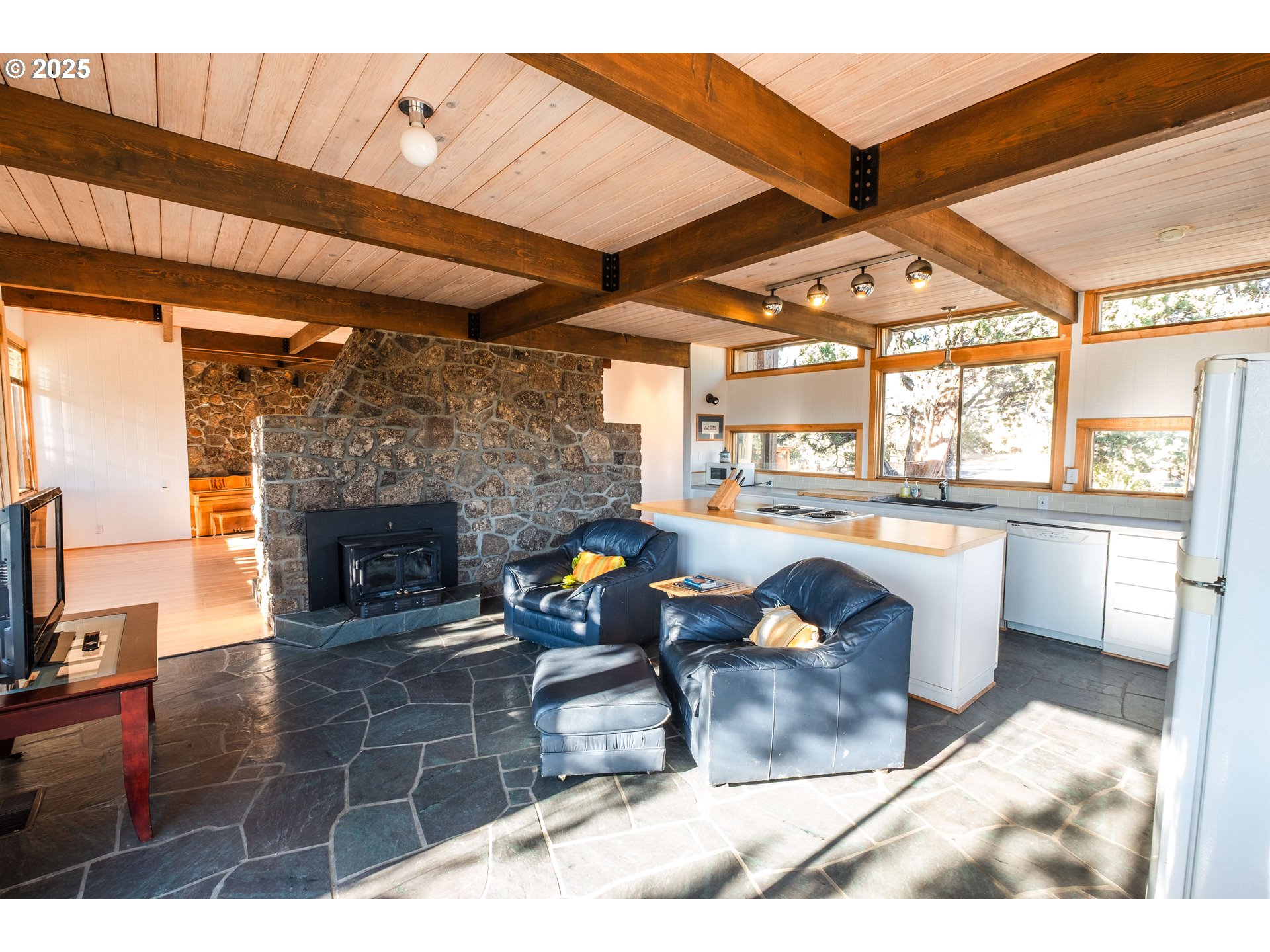 65255 Swalley Road Bend, OR 97703 - Photo 46 of 48 a living room with furniture a fireplace and a flat screen tv
