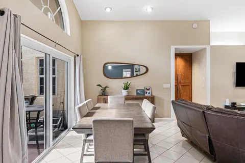 a living room with furniture a rug and a large window
