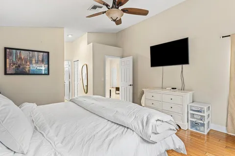 a bedroom with a bed and a flat screen tv