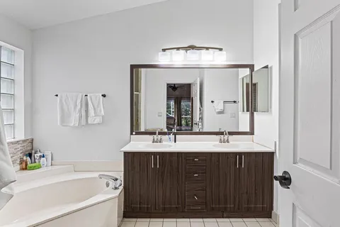 a bathroom with a sink double vanity and a bathtub