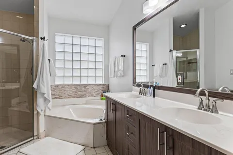 a bathroom with a tub sink and mirror