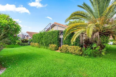 an aerial view of residential houses with outdoor space and lake view