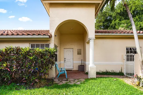 a view of front door of house with a yard