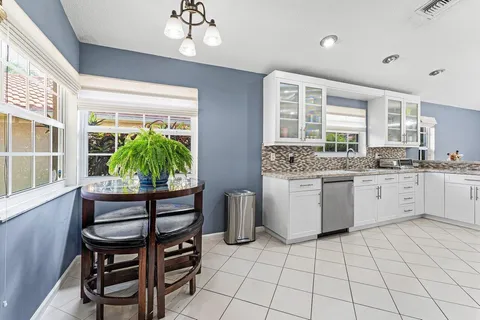 a kitchen with a stove a sink and a refrigerator