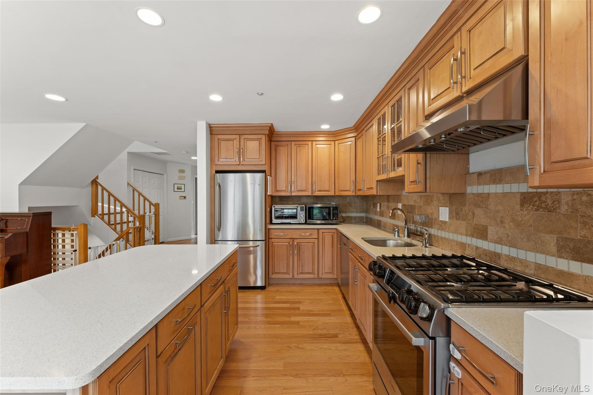 611 Pondside Drive White Plains, NY 10607 - Photo 7 of 40 Kitchen featuring wood-finish cabinetry, stainless steel appliances, and a gas range