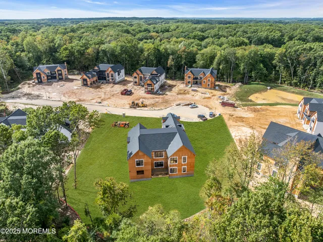 a view of a swimming pool with lawn chairs and plants