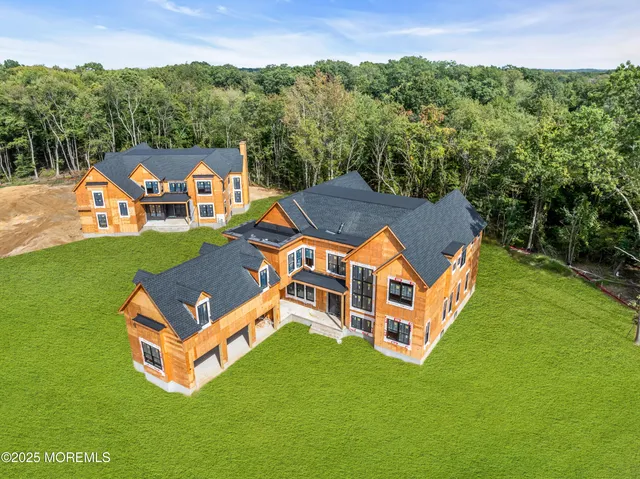 an aerial view of a house with a big yard