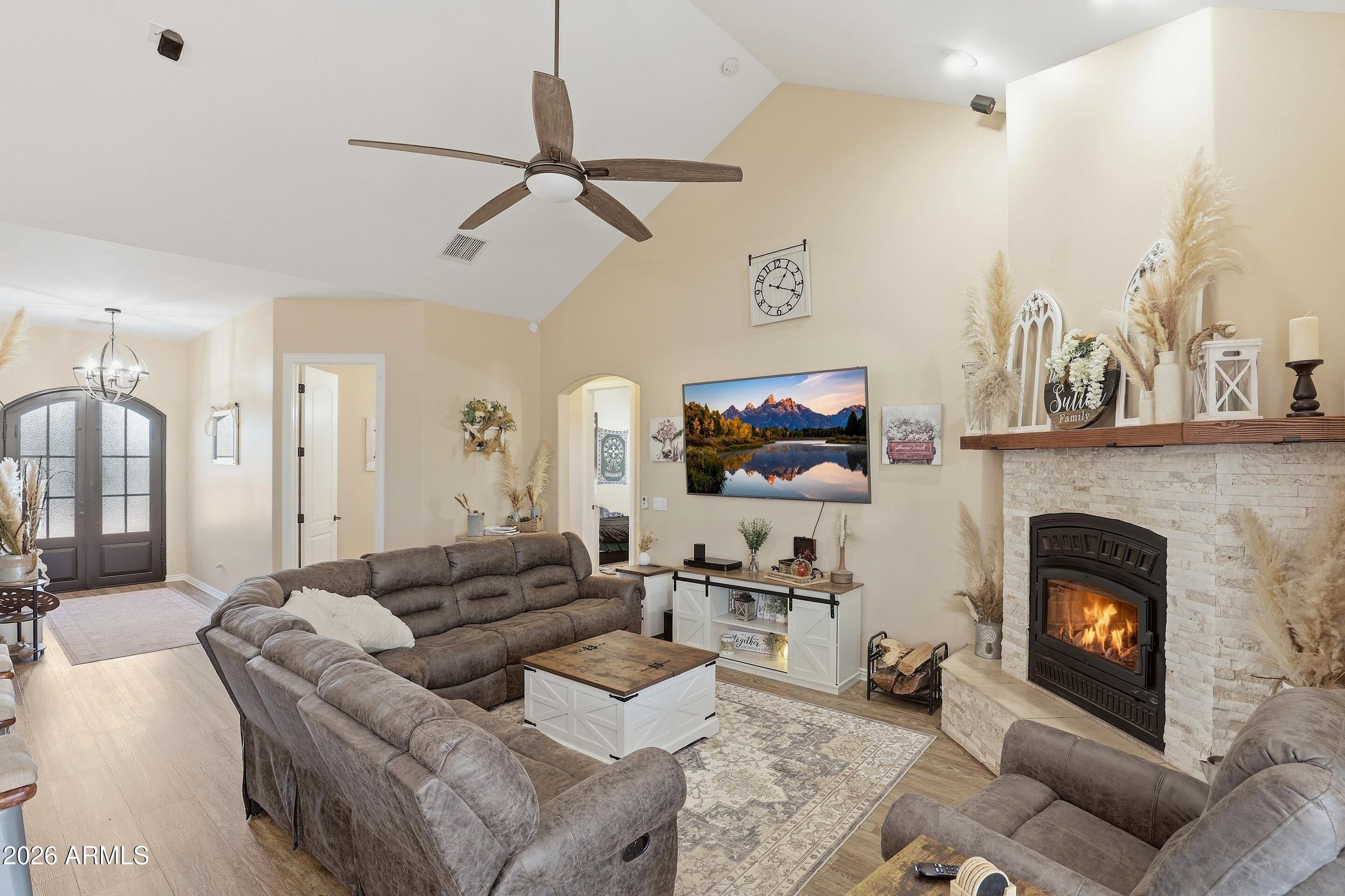 a living room with furniture a fireplace and a flat screen tv