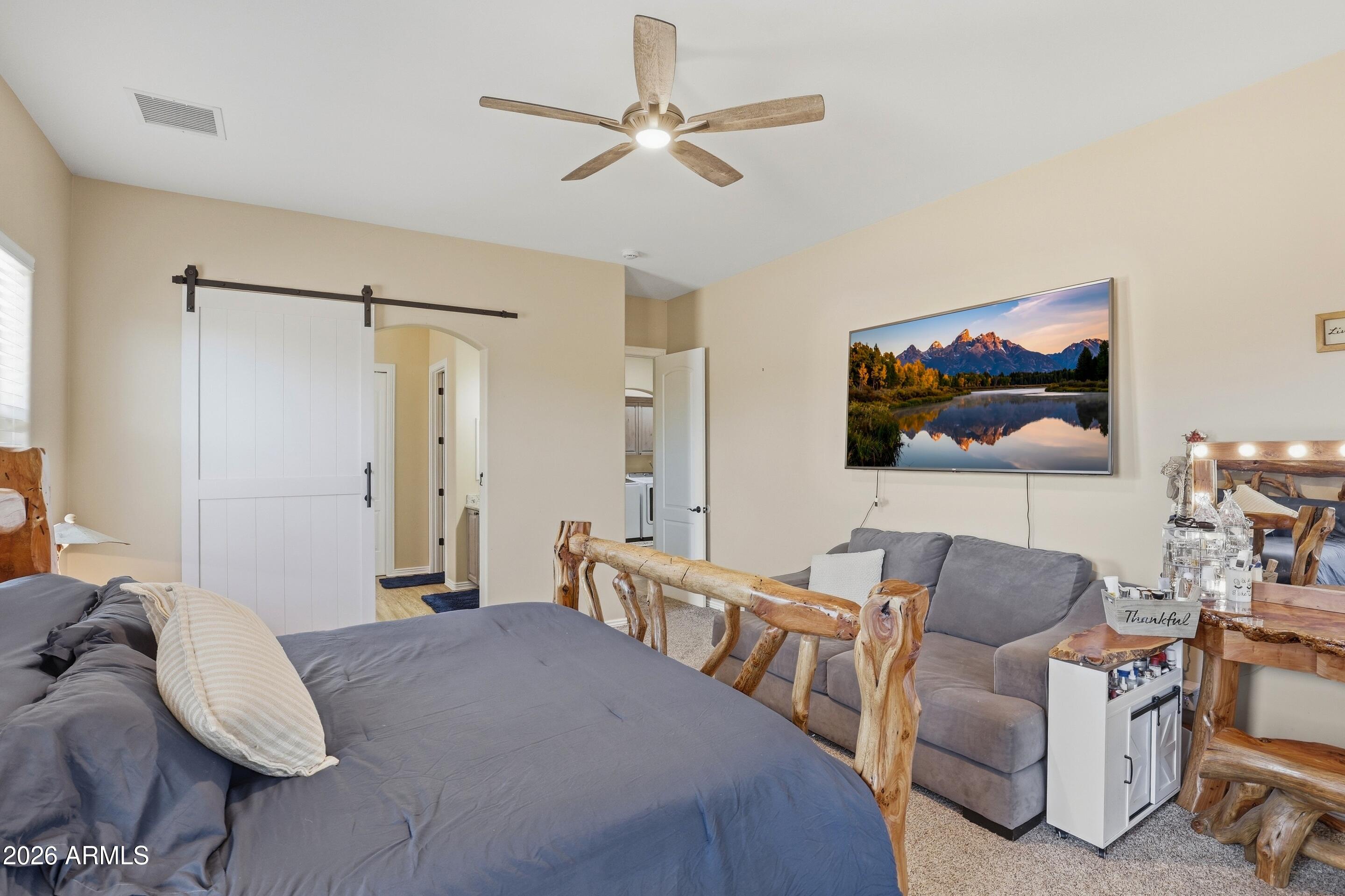 1206 East Bolivar Street Payson, AZ 85541 - Photo 13 of 43 a bedroom with a bed couch and a chandelier
