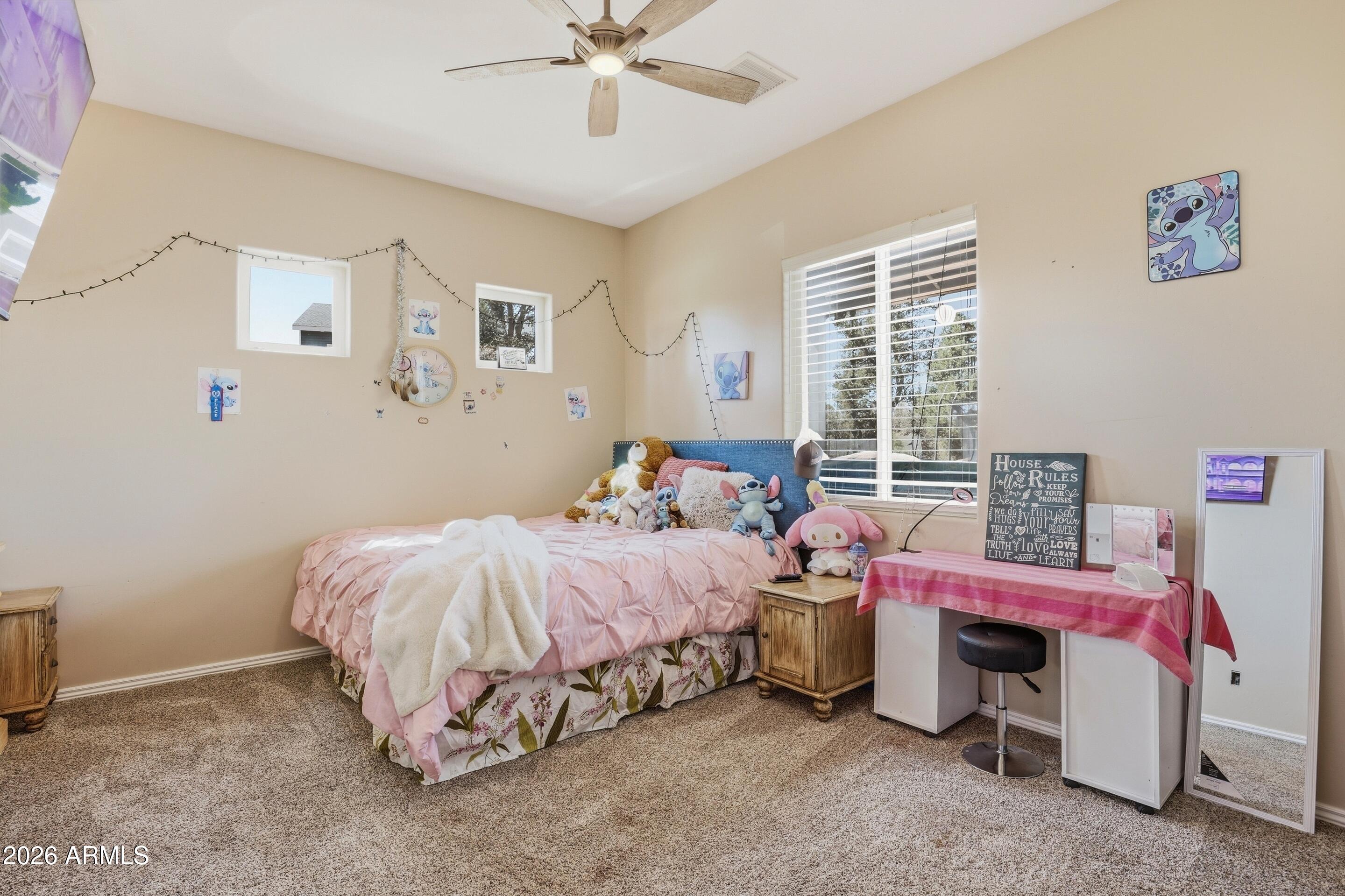1206 East Bolivar Street Payson, AZ 85541 - Photo 17 of 43 a bedroom with a bed and a chandelier
