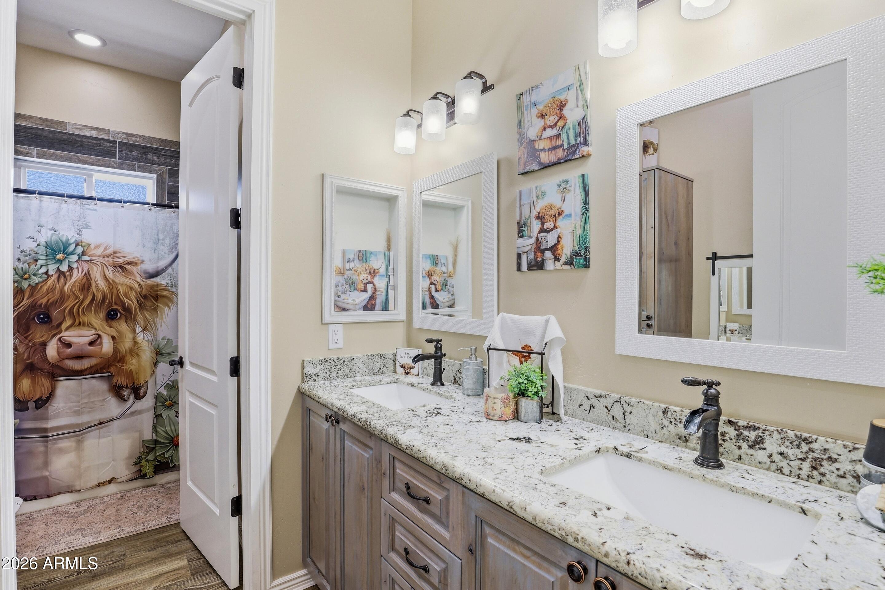 1206 East Bolivar Street Payson, AZ 85541 - Photo 19 of 43 a bathroom with a granite countertop sink a large mirror and a shower