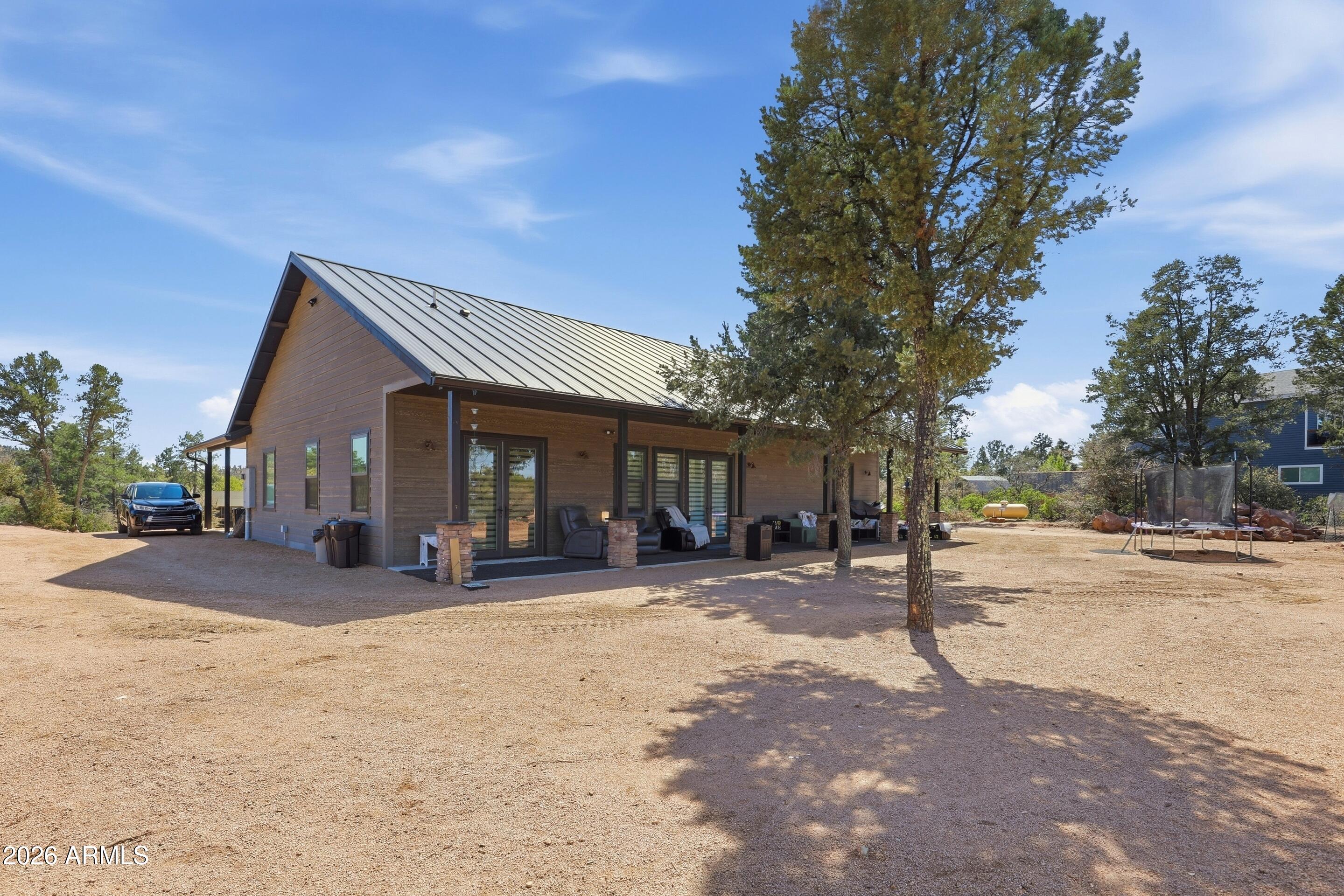 1206 East Bolivar Street Payson, AZ 85541 - Photo 24 of 43 a front view of a house with a yard and trees