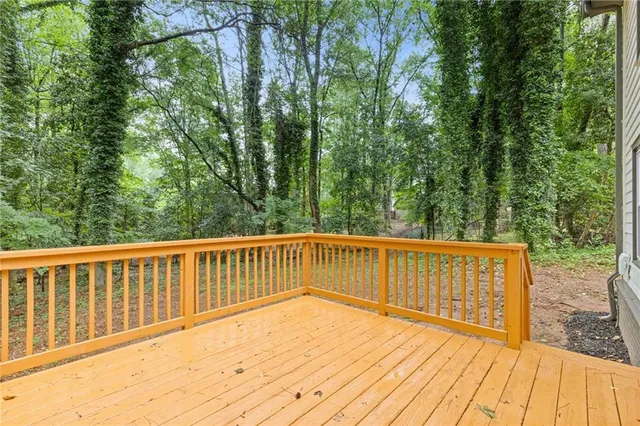 a view of balcony with wooden floor and fence