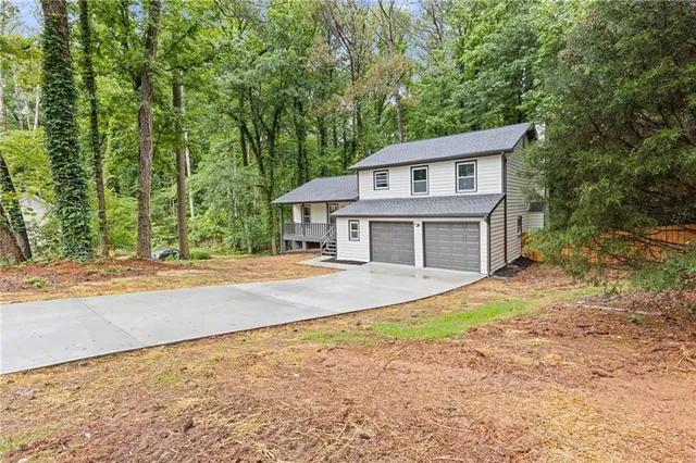 a house that has a tree in front of it