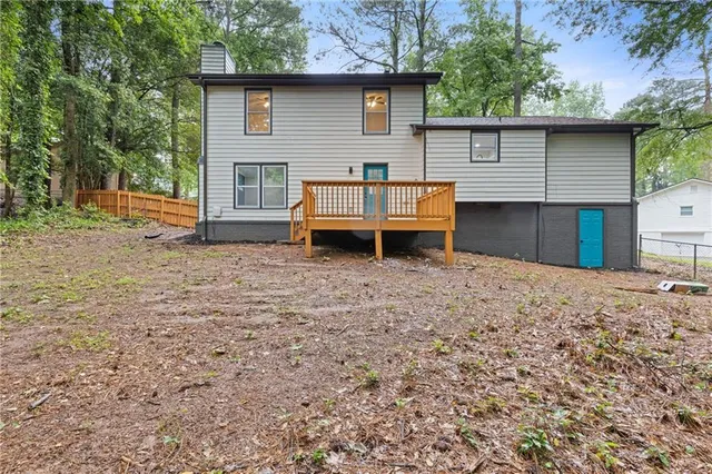 a view of a house with a yard and sitting area