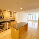 a kitchen with granite countertop a stove and a sink