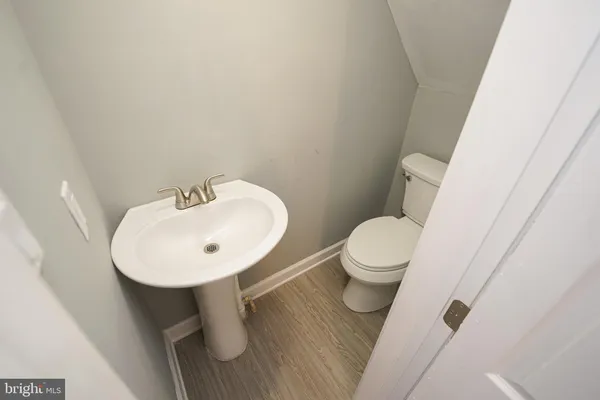 a bathroom with a toilet sink and a mirror