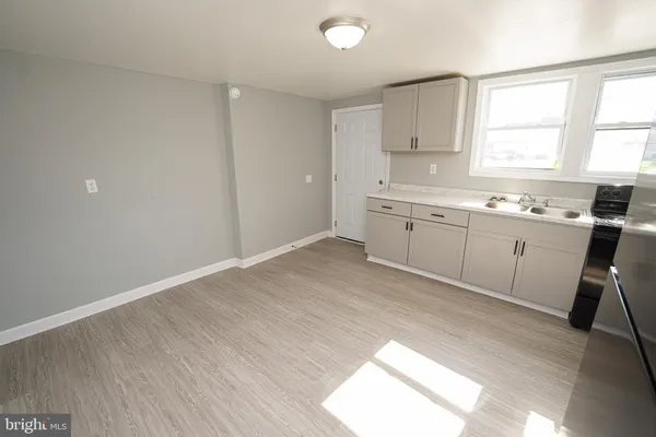 a kitchen with granite countertop a sink cabinets a window and stainless steel appliances