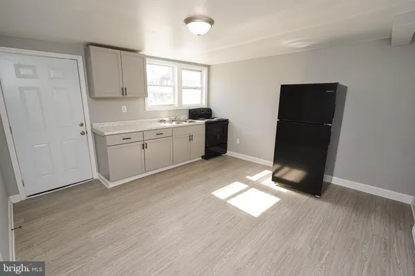 a room with hard wood floors and window