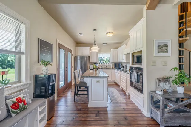 an open kitchen view with wooden floor and furniture