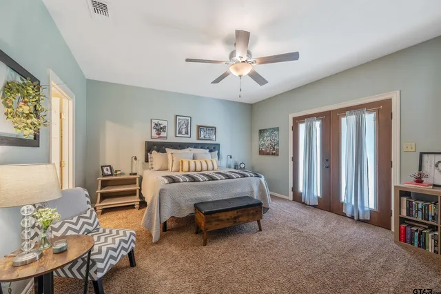 a bed sitting in a bedroom next to a window
