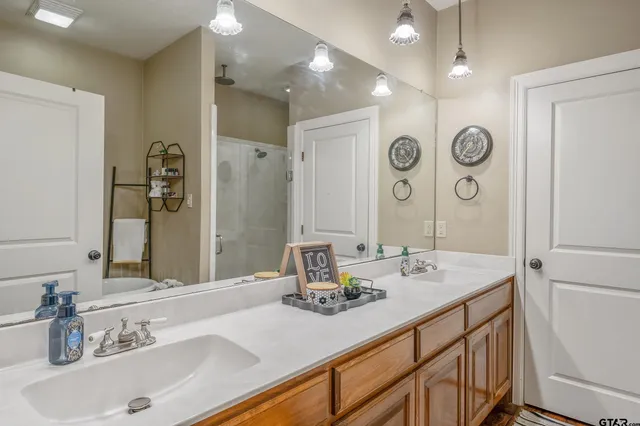 a bathroom with a sink double vanity and a mirror