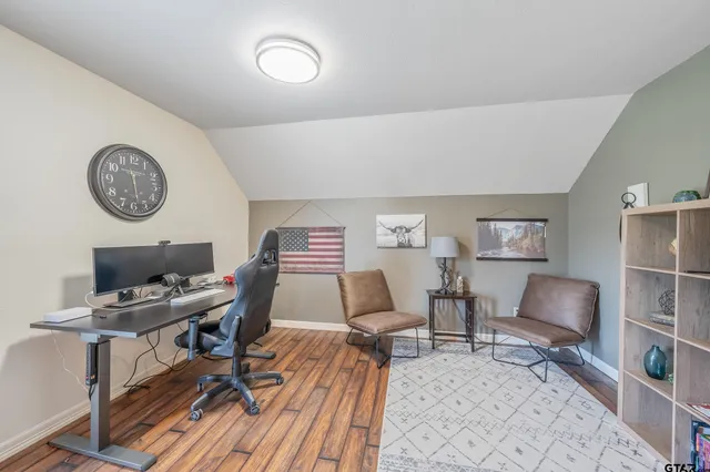 a work room with furniture and a clock