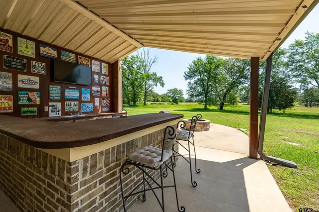 a view of a patio with a table chairs and a backyard