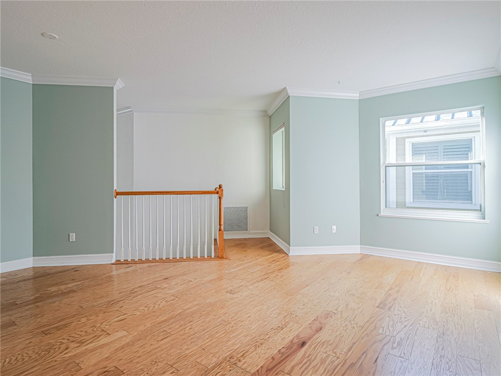 1835 Bridgepointe Circle, Unit 18 Vero Beach, FL 32967 - Photo 15 of 34 an empty room with wooden floor cabinet and windows