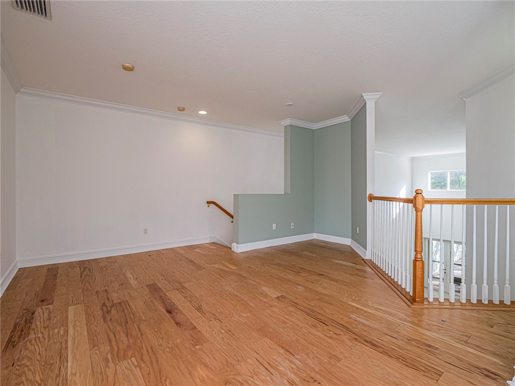 1835 Bridgepointe Circle, Unit 18 Vero Beach, FL 32967 - Photo 16 of 34 a view of a livingroom with wooden floor