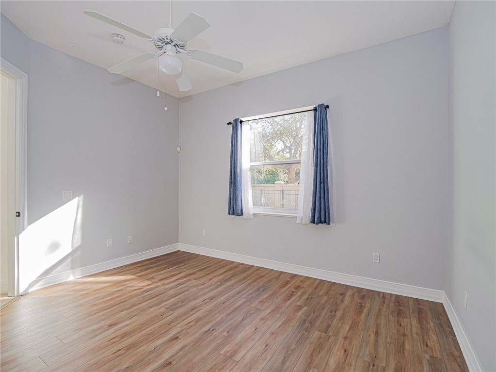 1835 Bridgepointe Circle, Unit 18 Vero Beach, FL 32967 - Photo 24 of 34 wooden floor in an empty room with a window