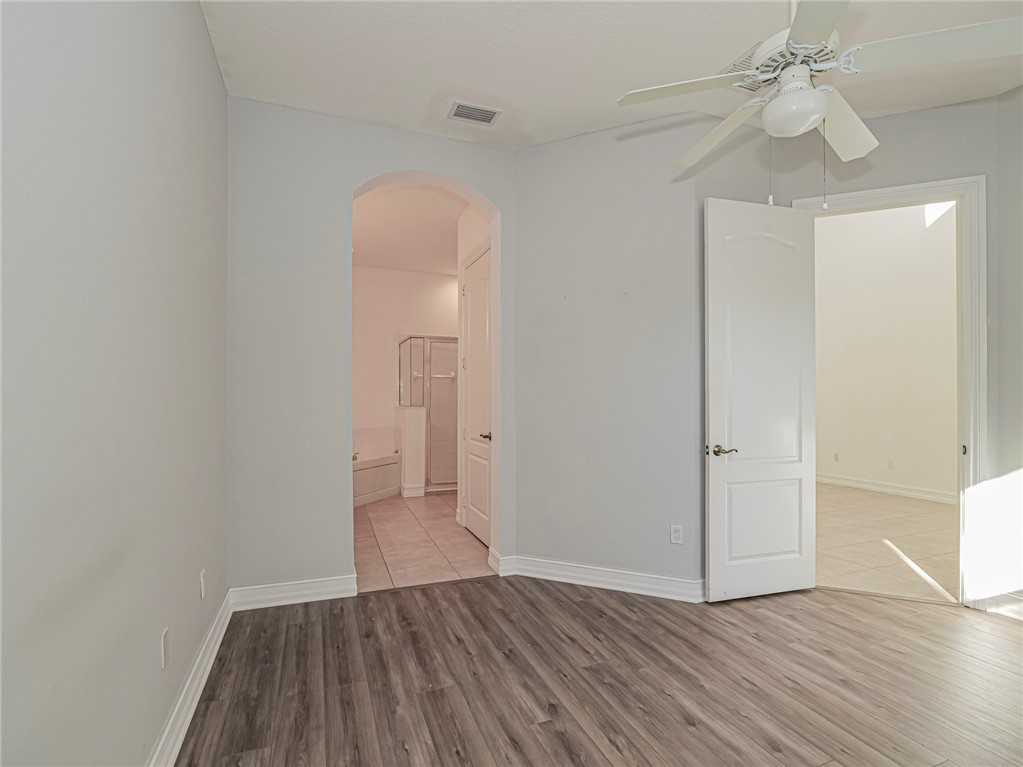 1835 Bridgepointe Circle, Unit 18 Vero Beach, FL 32967 - Photo 25 of 34 wooden floor in an empty room with a window