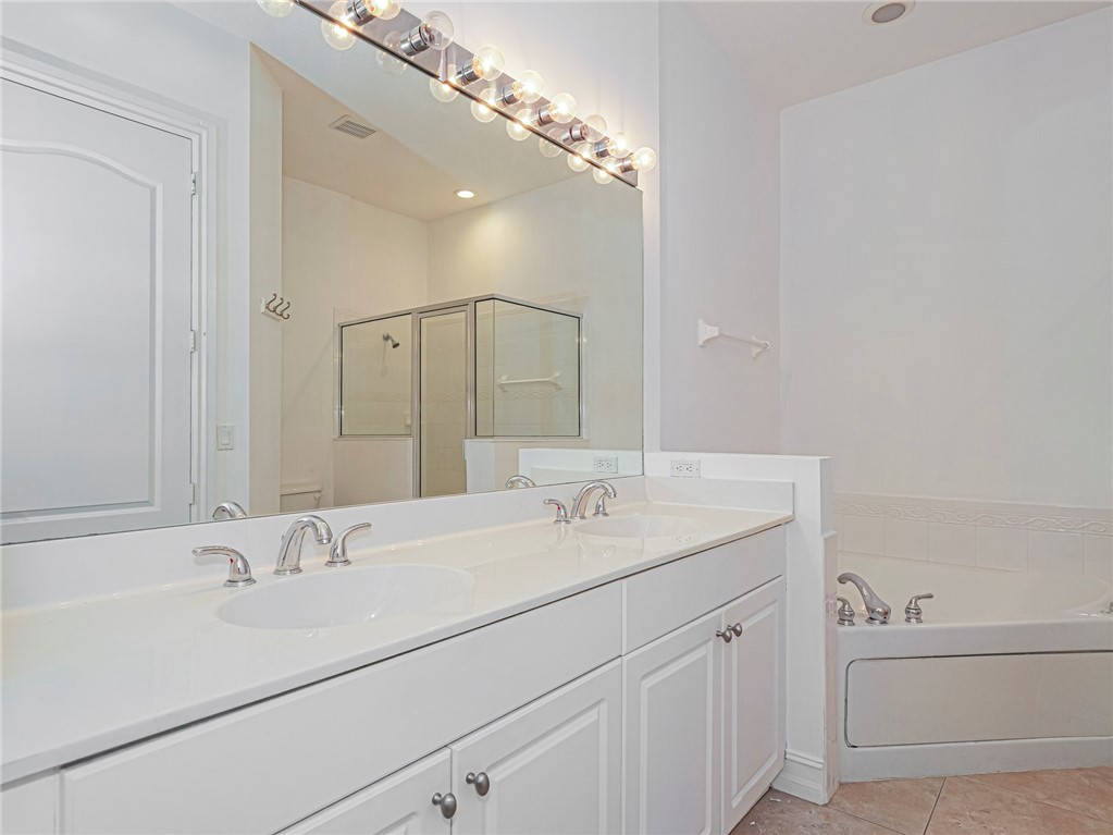 1835 Bridgepointe Circle, Unit 18 Vero Beach, FL 32967 - Photo 26 of 34 a bathroom with a sink and a mirror