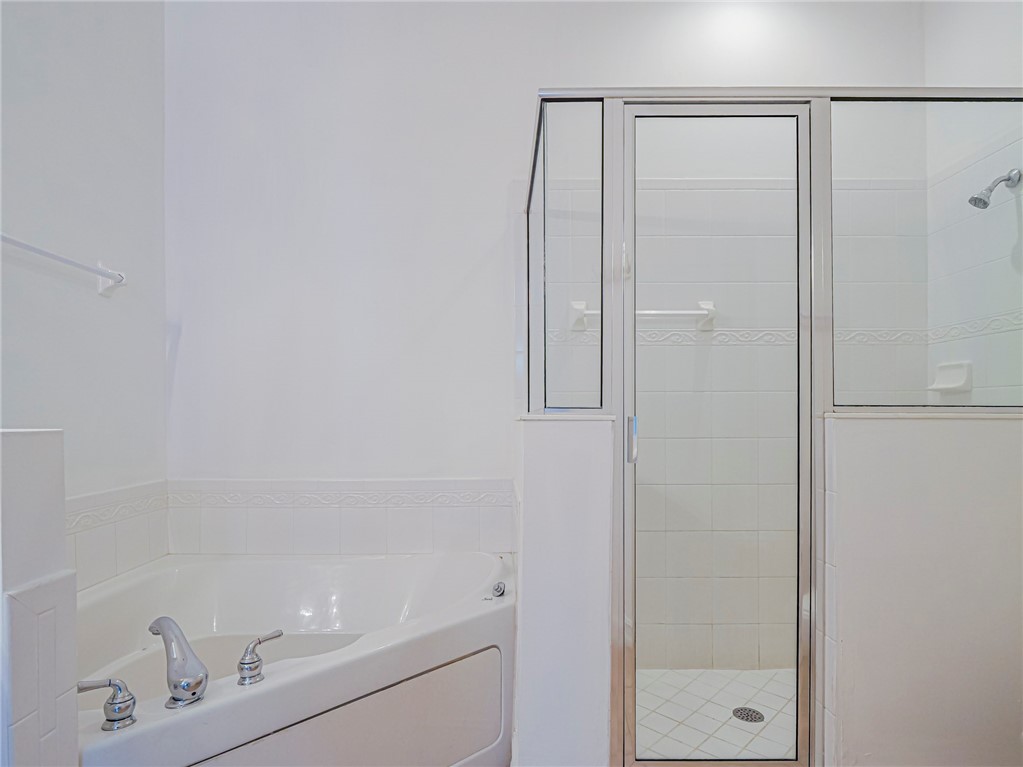 1835 Bridgepointe Circle, Unit 18 Vero Beach, FL 32967 - Photo 27 of 34 a bathroom with a shower and a sink