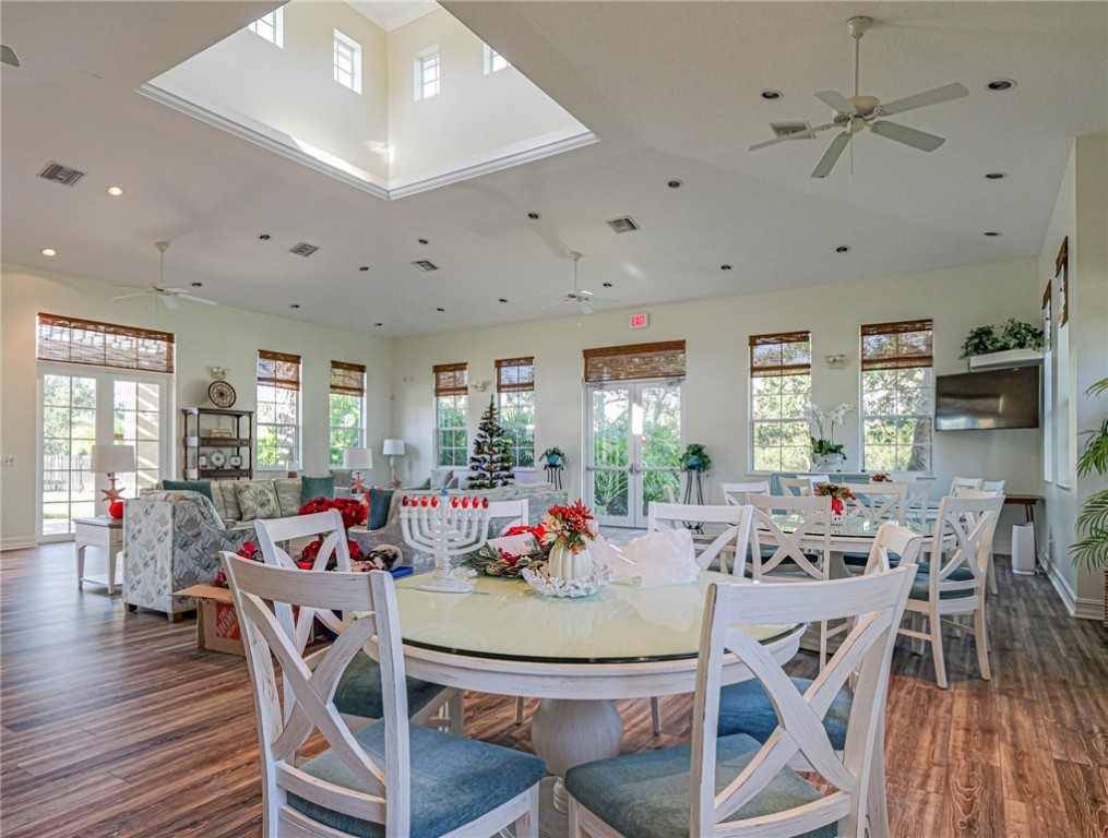 1835 Bridgepointe Circle, Unit 18 Vero Beach, FL 32967 - Photo 31 of 34 a view of a dining room with furniture window and wooden floor