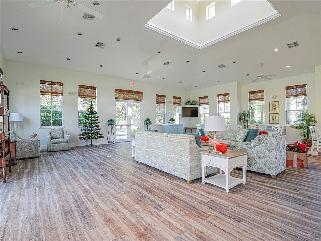 1835 Bridgepointe Circle, Unit 18 Vero Beach, FL 32967 - Photo 32 of 34 a living room with furniture and wooden floor