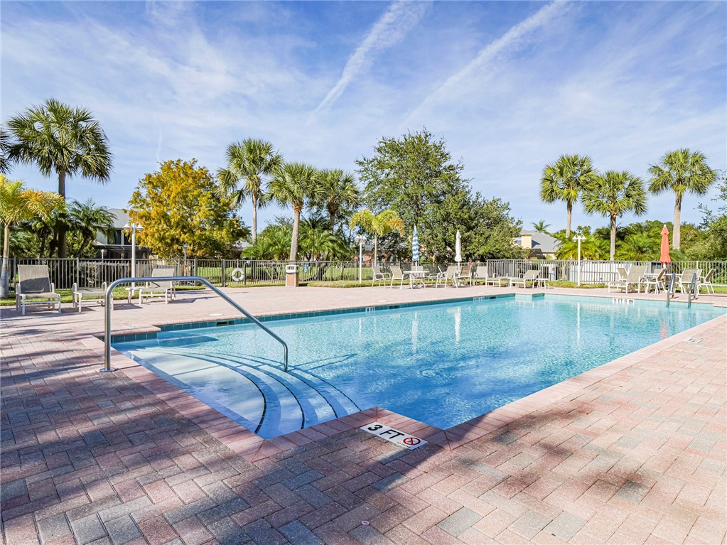 1835 Bridgepointe Circle, Unit 18 Vero Beach, FL 32967 - Photo 34 of 34 a view of a swimming pool with a yard