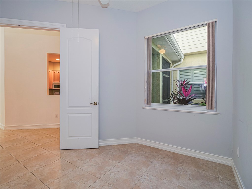 1835 Bridgepointe Circle, Unit 18 Vero Beach, FL 32967 - Photo 5 of 34 an empty room with window and mirror