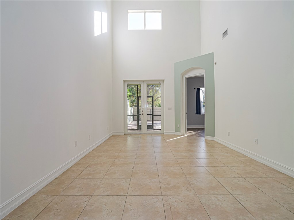 1835 Bridgepointe Circle, Unit 18 Vero Beach, FL 32967 - Photo 7 of 34 an empty room with windows and closet