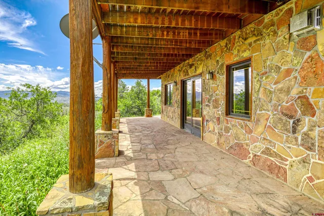 a view of balcony with wooden floor and fence