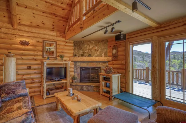 a living room with furniture a flat screen tv and a fireplace