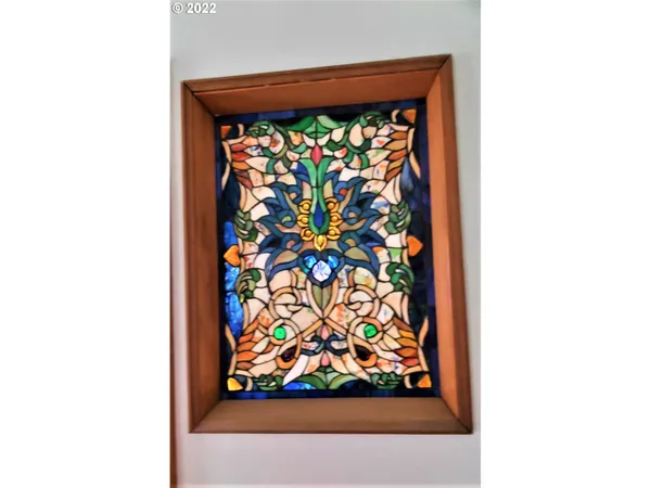 a kitchen view with wooden floor and electronic appliances