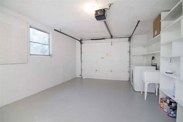 a view of a storage & utility room with two washing machine