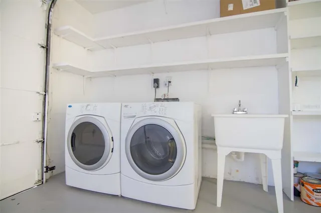 a utility room with sink dryer and washer