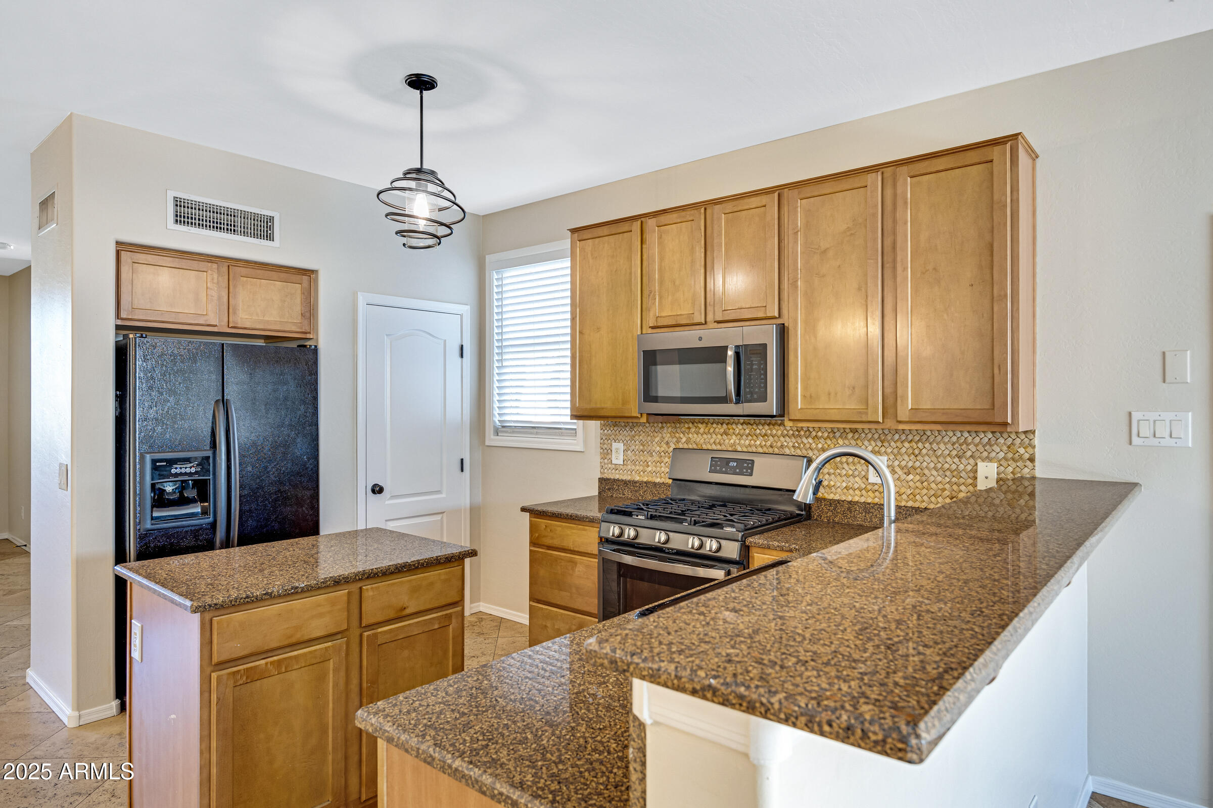 2315 East Pecan Road Phoenix, AZ 85040 - Photo 12 of 36 a kitchen with stainless steel appliances granite countertop a sink stove and refrigerator