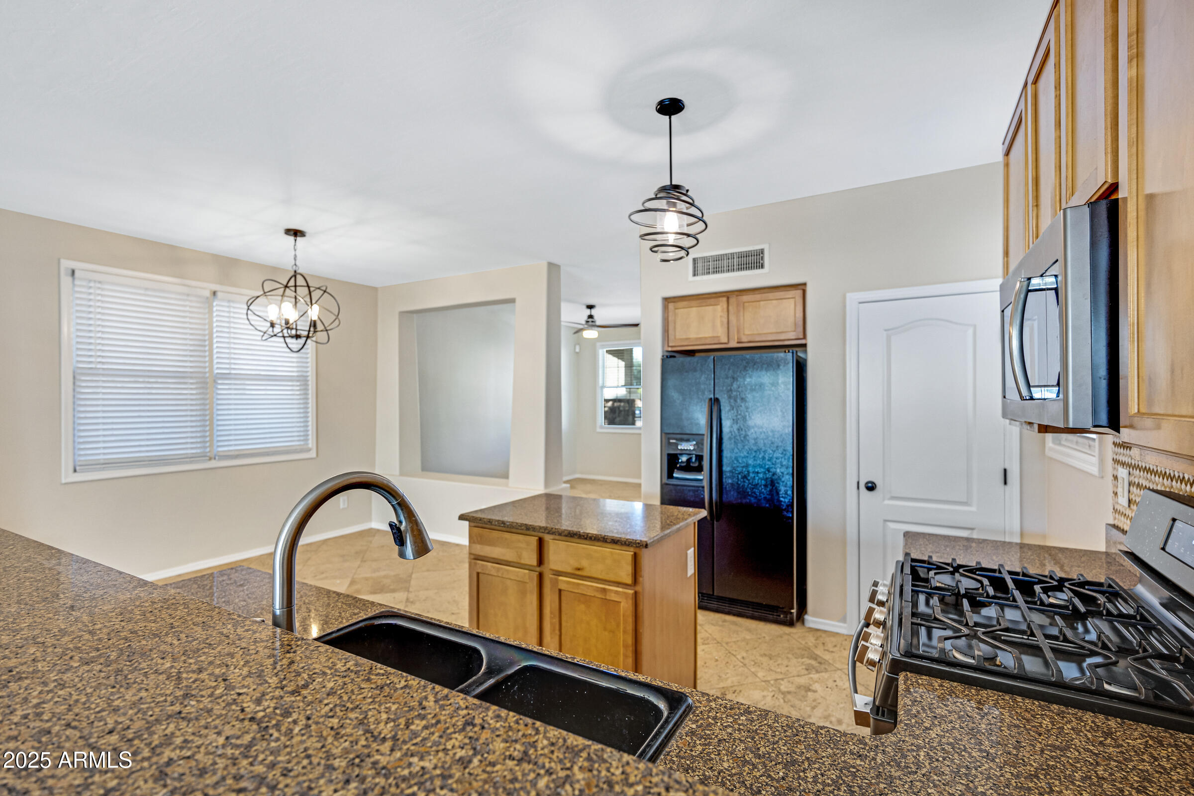2315 East Pecan Road Phoenix, AZ 85040 - Photo 13 of 36 a kitchen with stainless steel appliances granite countertop a stove a refrigerator and a sink