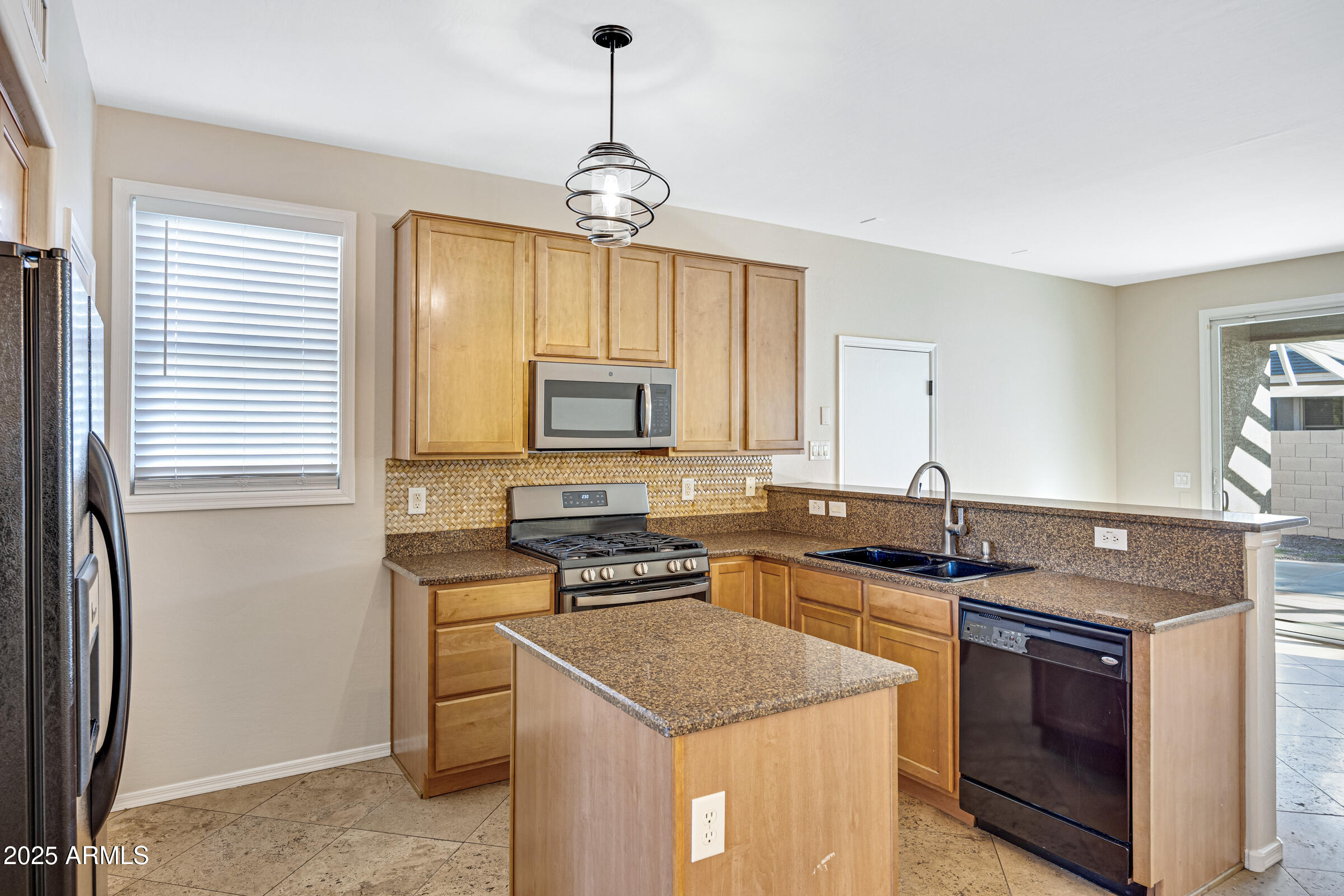 2315 East Pecan Road Phoenix, AZ 85040 - Photo 15 of 36 a kitchen with stainless steel appliances granite countertop a sink stove and cabinets