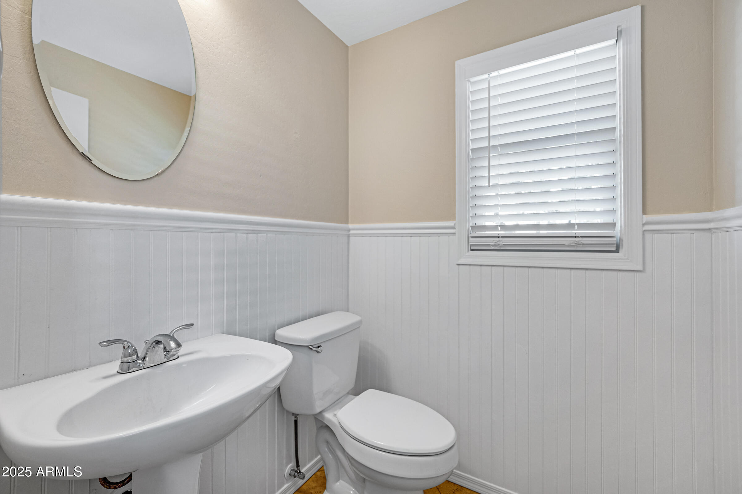 2315 East Pecan Road Phoenix, AZ 85040 - Photo 20 of 36 a bathroom with a toilet a sink a mirror and a window