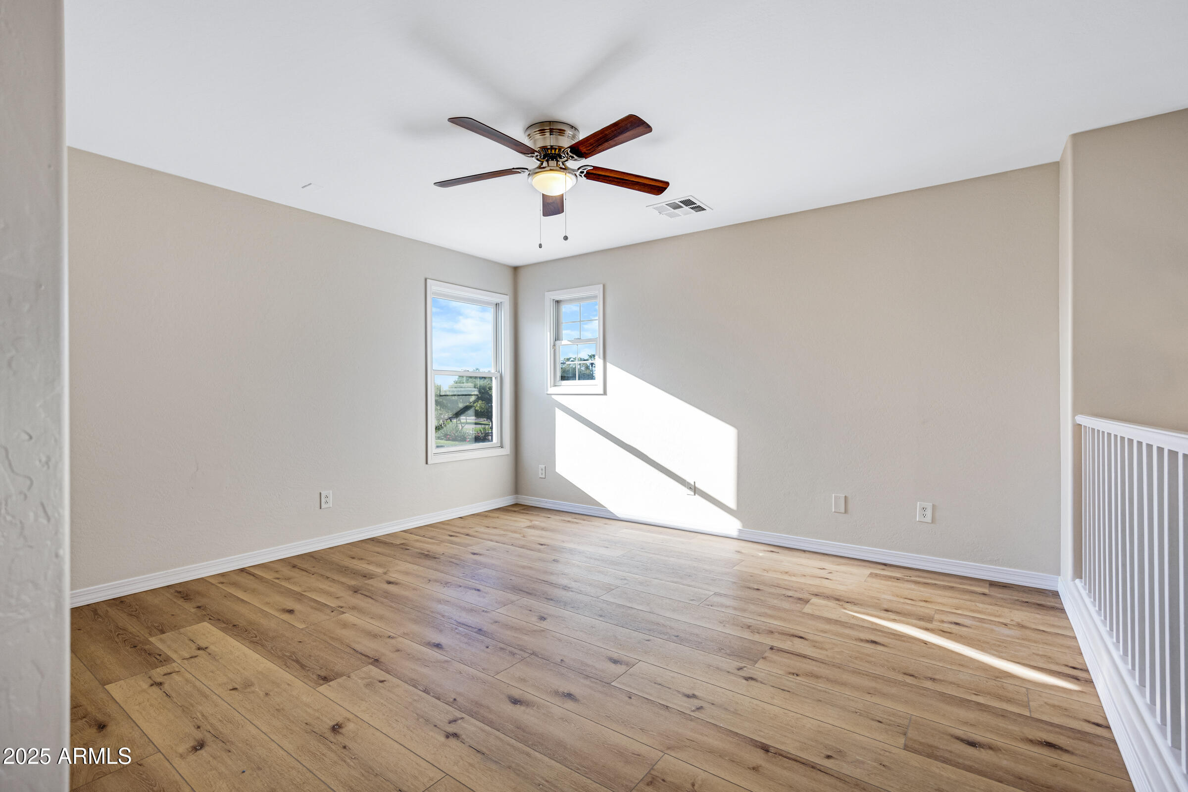 2315 East Pecan Road Phoenix, AZ 85040 - Photo 22 of 36 a view of empty room with wooden floor and fan