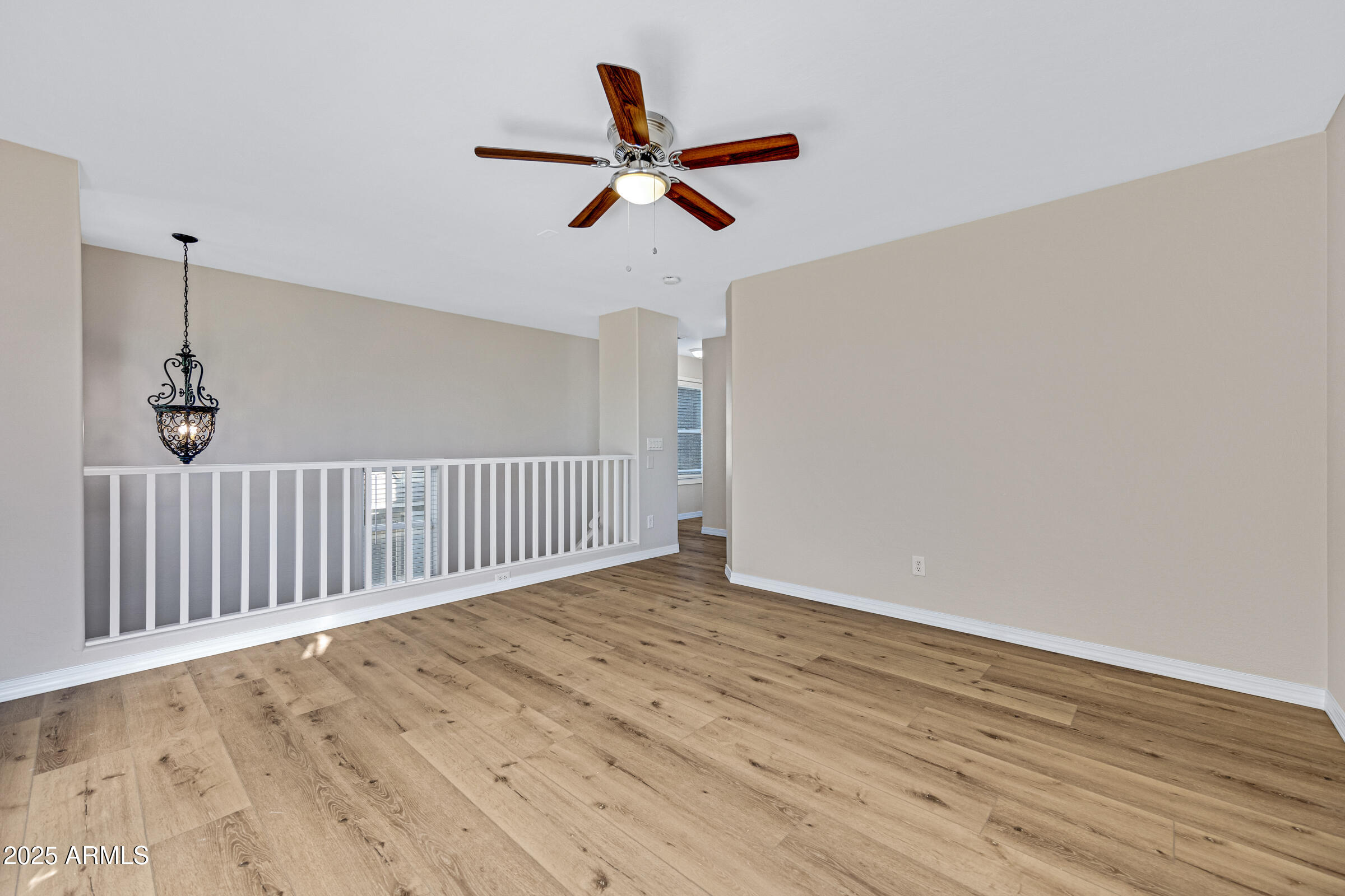 2315 East Pecan Road Phoenix, AZ 85040 - Photo 23 of 36 a view of a room with wooden floor and a ceiling fan